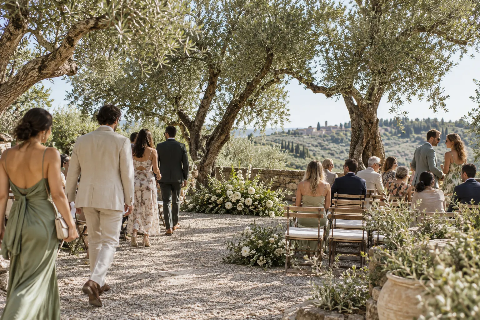 Simple outdoor ceremony seating beneath olive trees